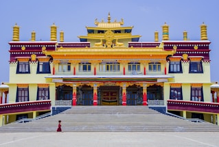 Elegant office building entrance with maroon and gold accents reflecting Rajasthan heritage.