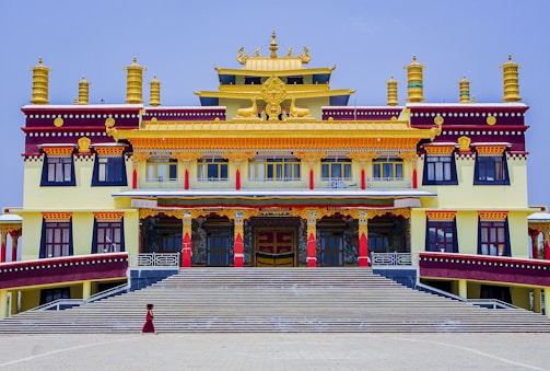 Elegant office building entrance with maroon and gold accents reflecting Rajasthan heritage.
