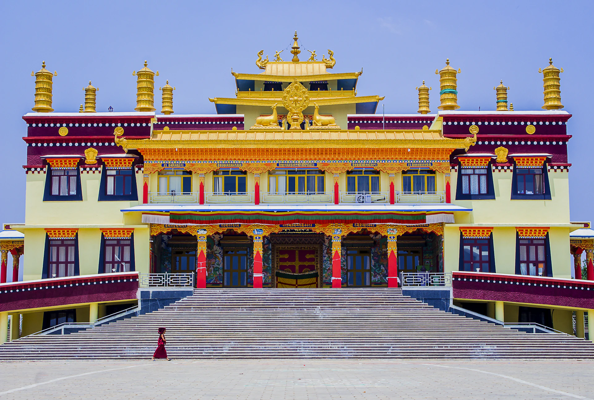 A close-up of the college's main building facade, featuring the navy blue and saffron orange color scheme with the college name prominently displayed.