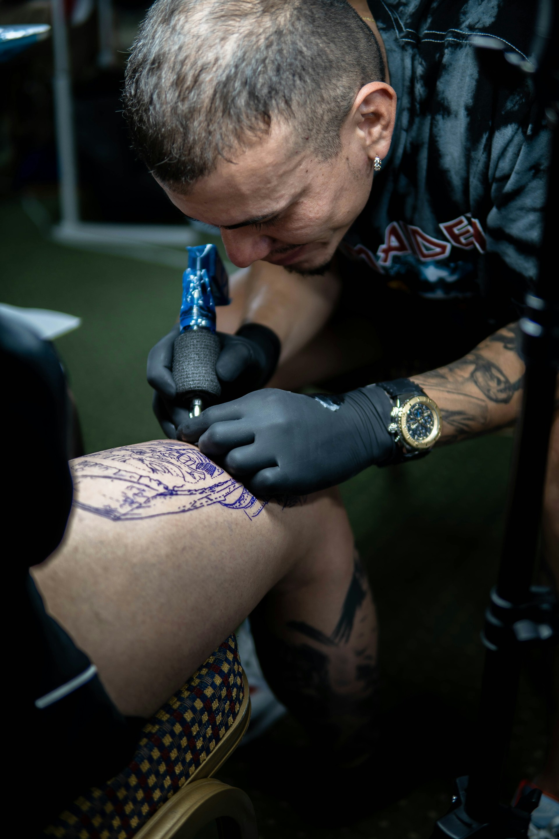 a man with tattoos holding a drill