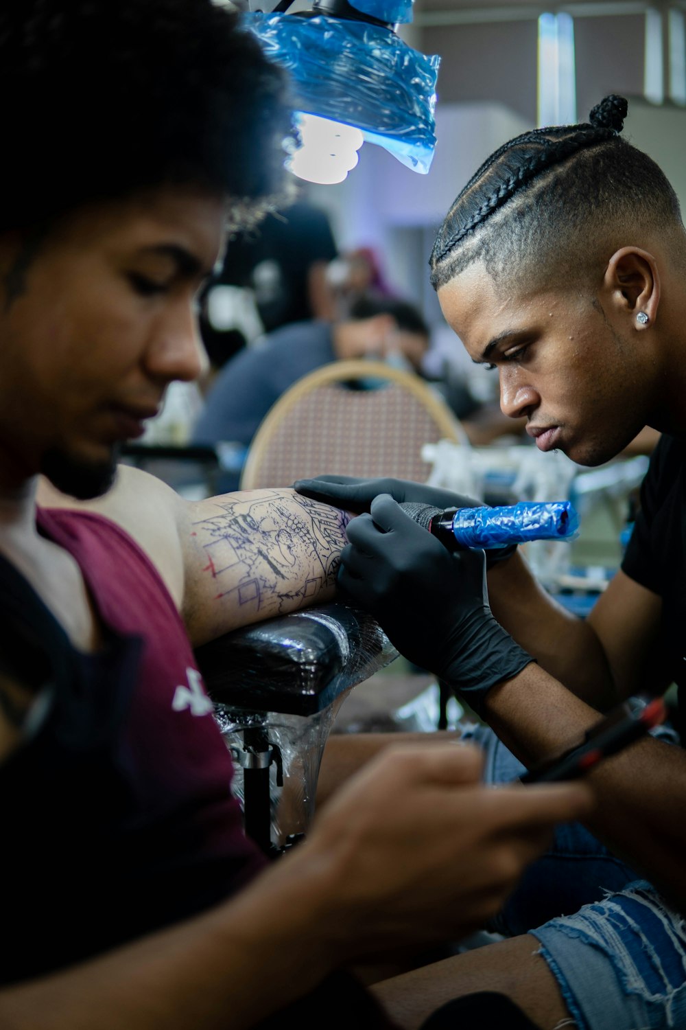 a man with tattoos holding a microphone