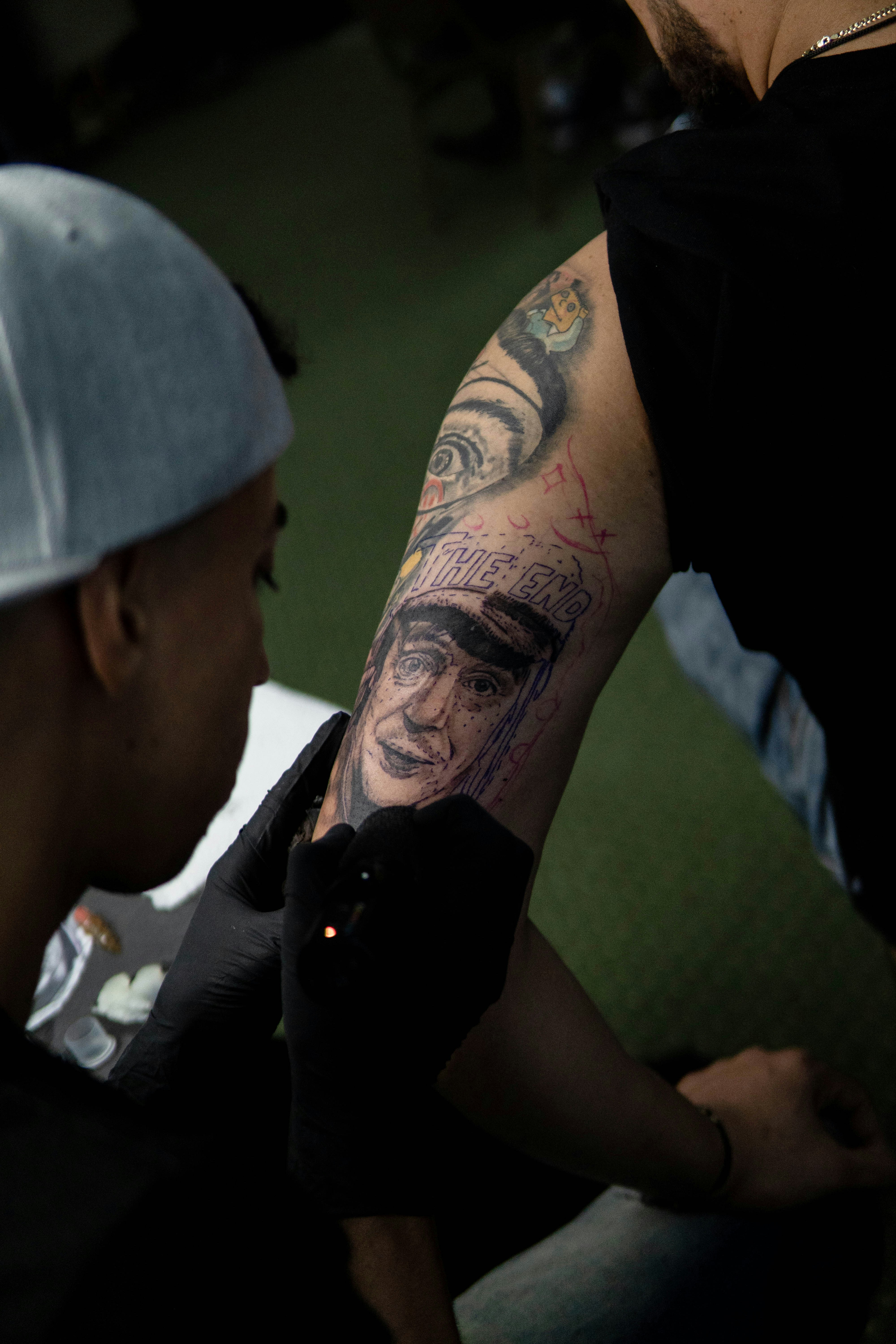 a man with tattoos on his arm