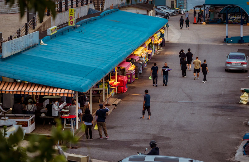 Korean street food scene with various traditional dishes and snacks
