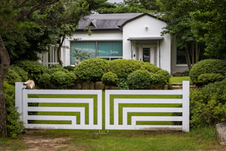 a white fence in front of a house
