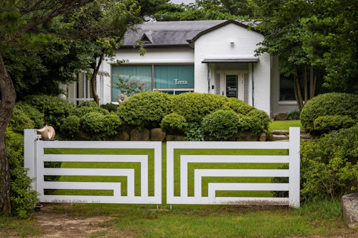 a white fence in front of a house
