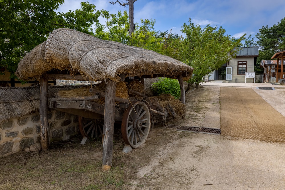 a wooden cart with a straw roof