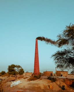 a tall tower with smoke coming out of it