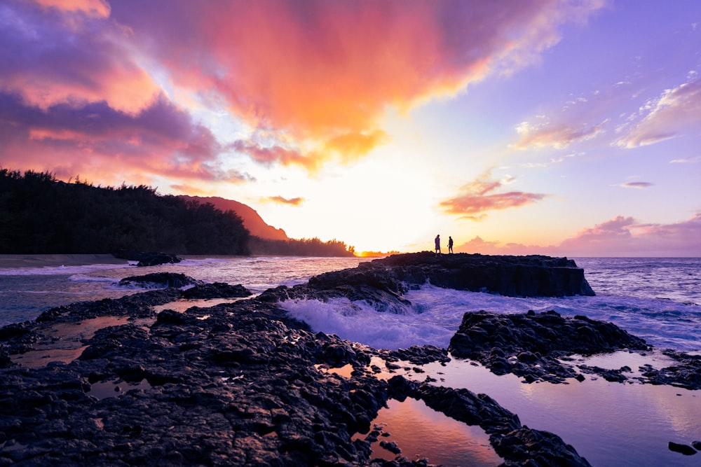 a rocky beach with a sunset