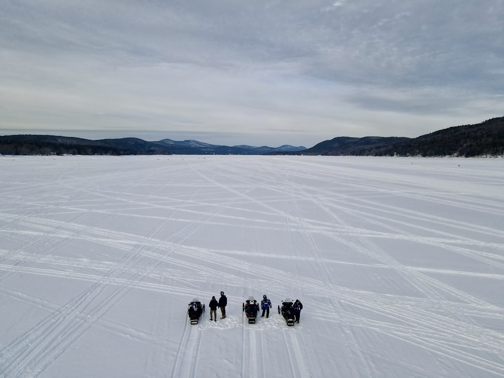 a group of people walking on a snowy field