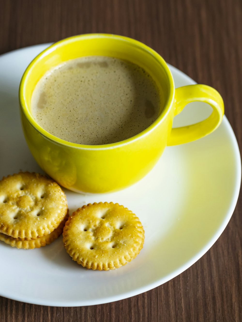 a cup of tea next to some cookies