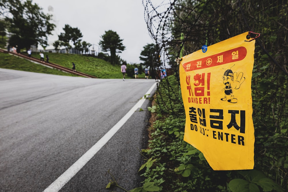 a yellow sign on the side of a road