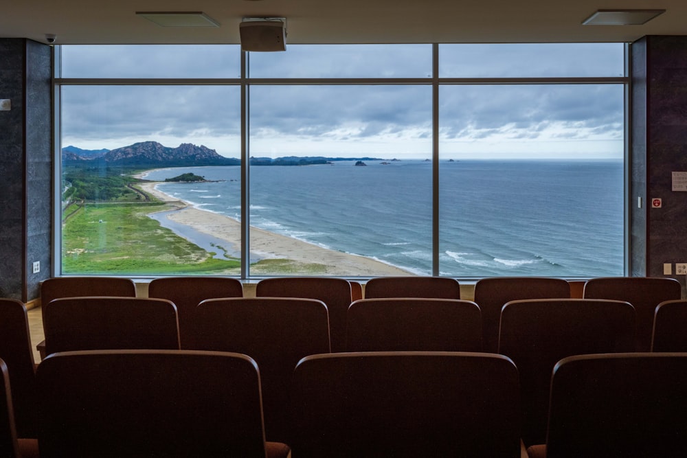 a room with chairs and a view of the ocean