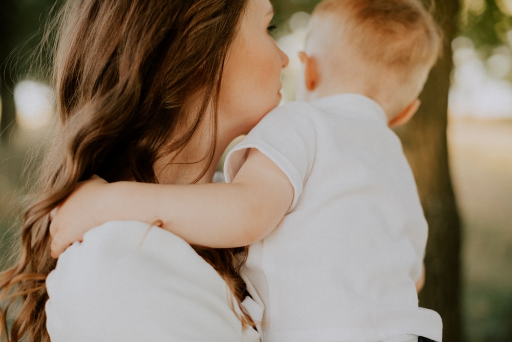 a woman kissing a baby