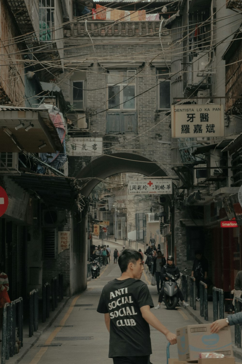 a man carrying a box on a street