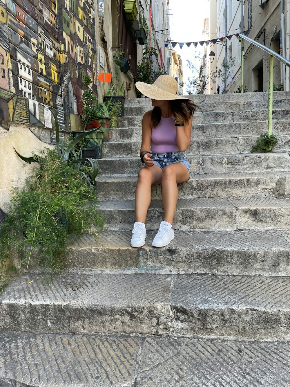 a woman sitting on a set of stairs
