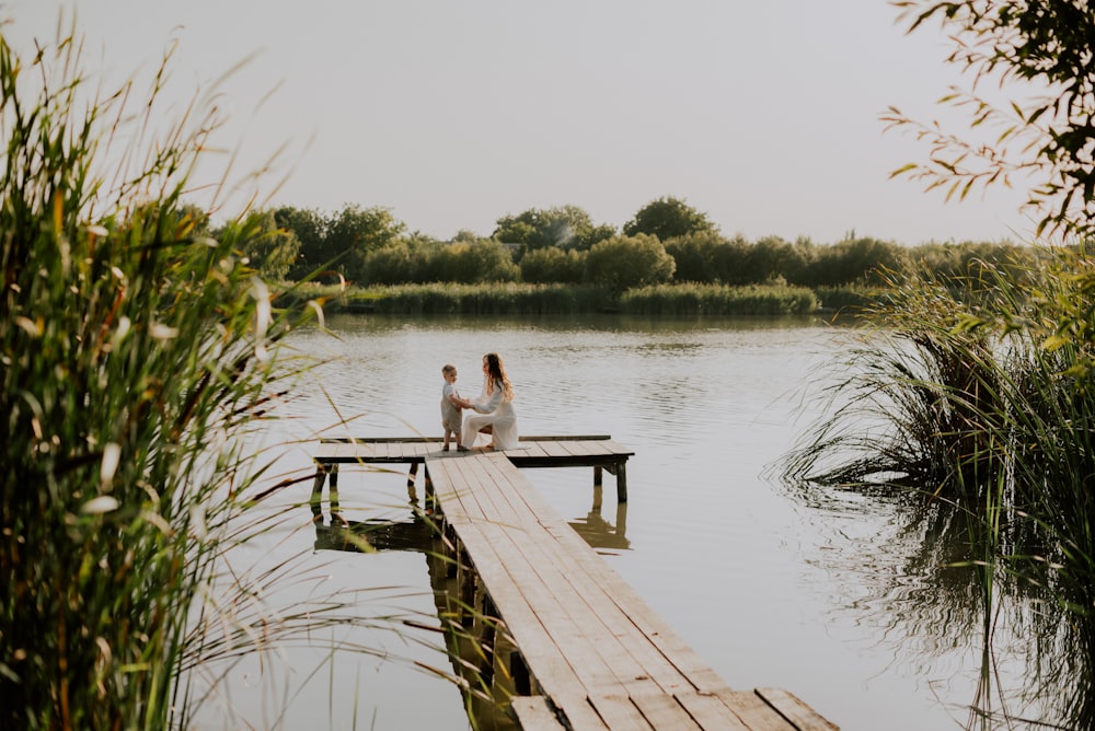 a couple sitting on a dock