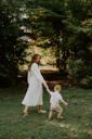 a man and a child walking in a park