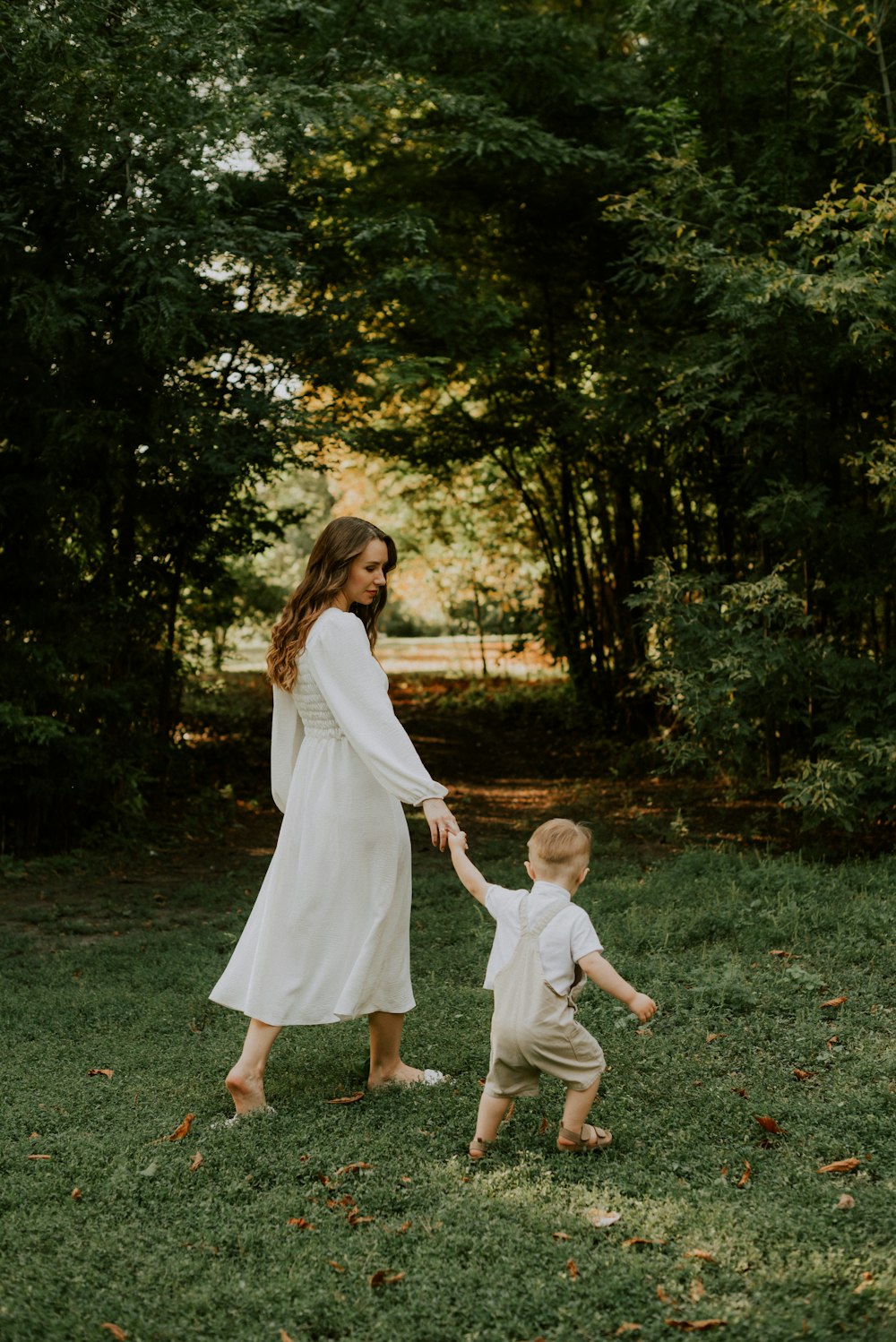 a man and a child walking in a park