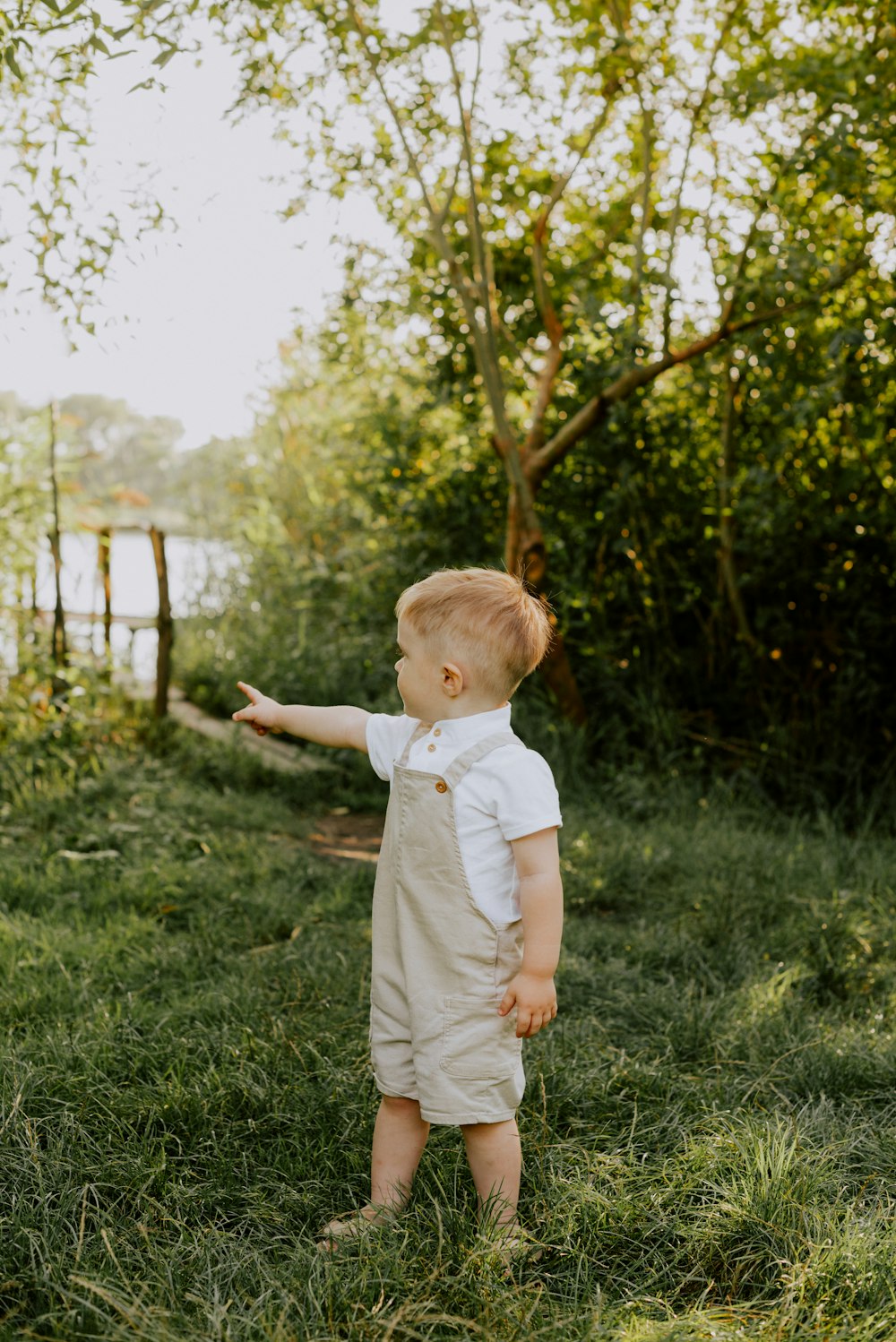 a baby standing in grass