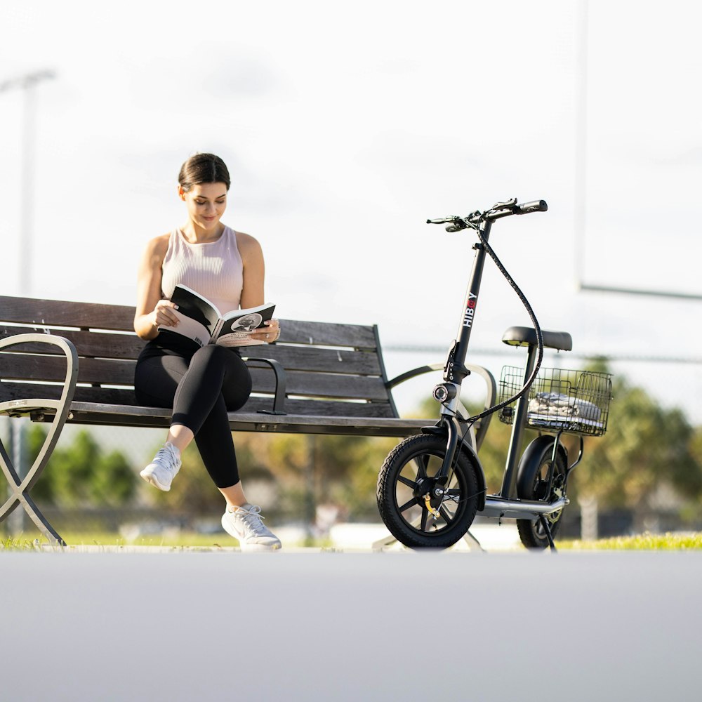 a person sitting on a bench with a bicycle and a bike