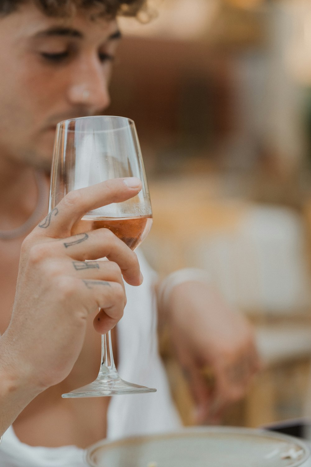 a person drinking a glass of wine