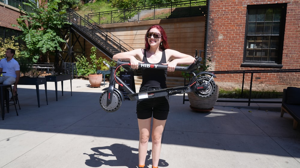 a woman holding a bike