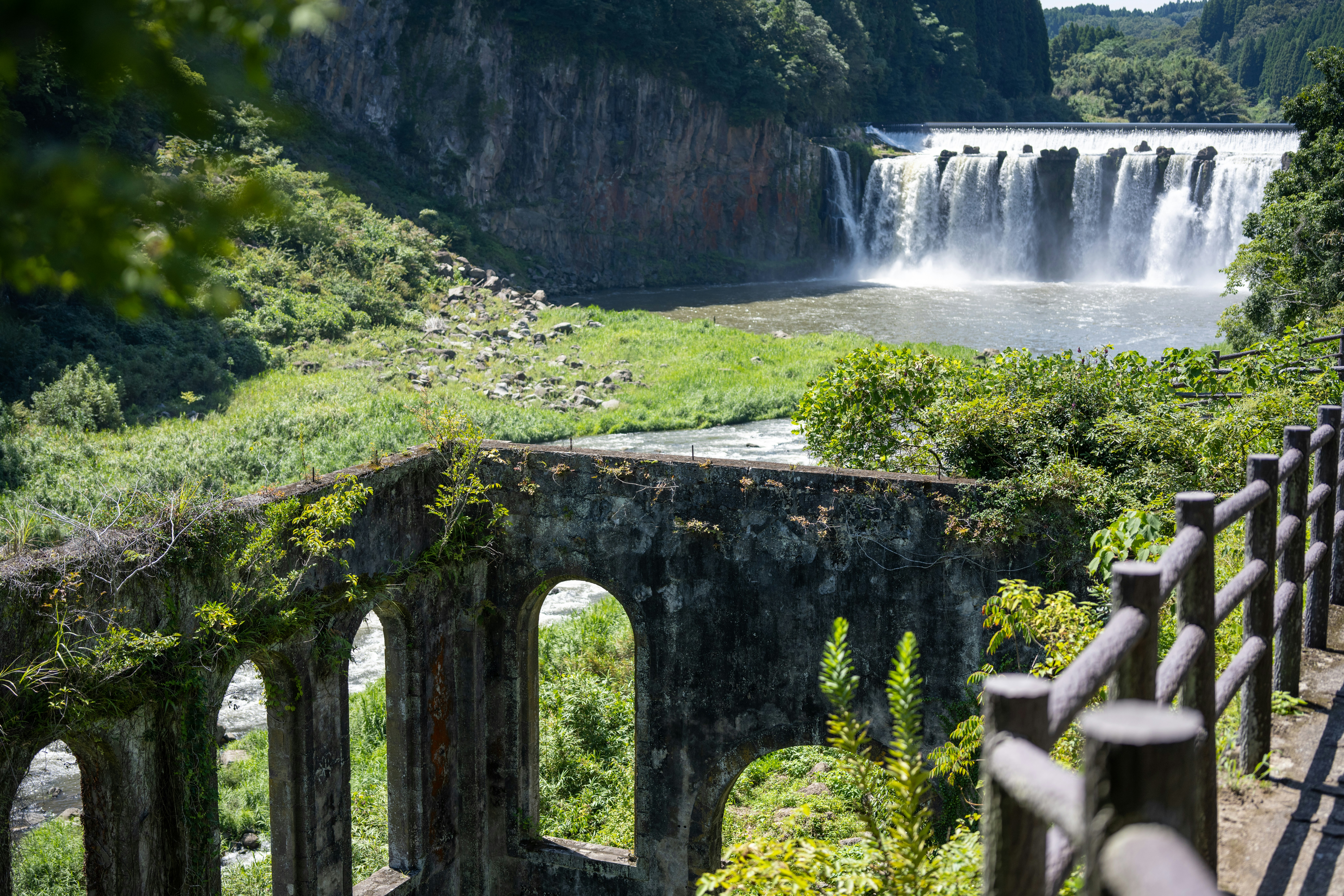 A waterfall over a bridge photo – Free Outdoors Image on Unsplash