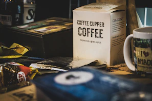 A cheerful customer unboxing a fresh Turfscape coffee pack at their cozy kitchen counter.