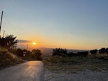 A team inspecting a newly constructed rural road at sunset.
