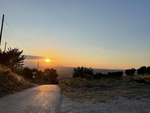 A team inspecting a newly constructed rural road at sunset.