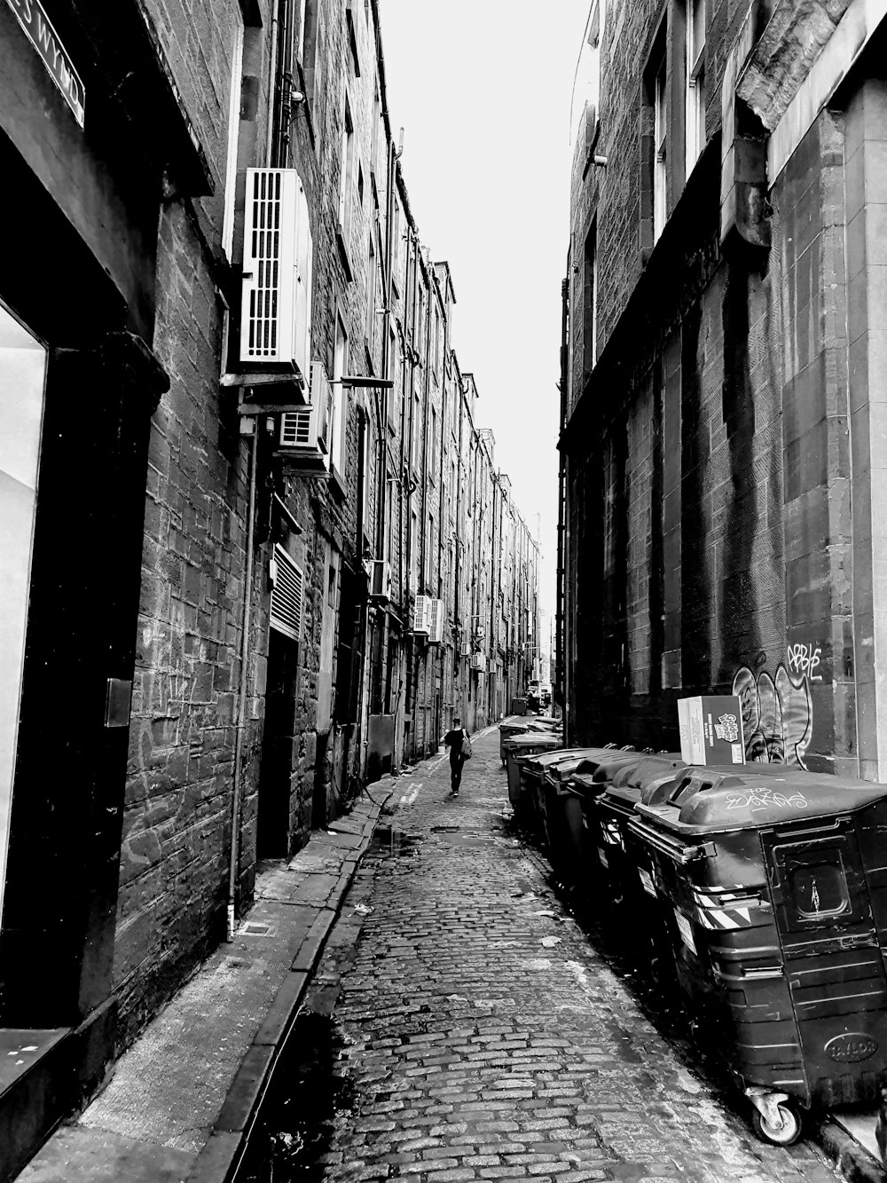 a cobblestone street with buildings on either side of it