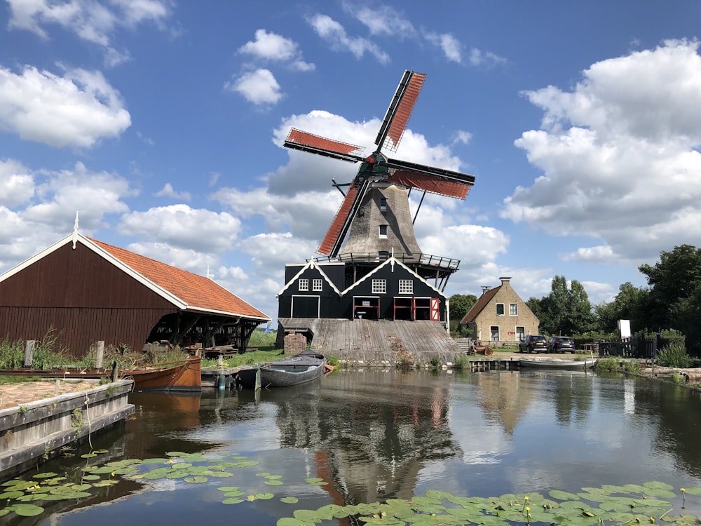 a building with a pointed roof by a body of water
