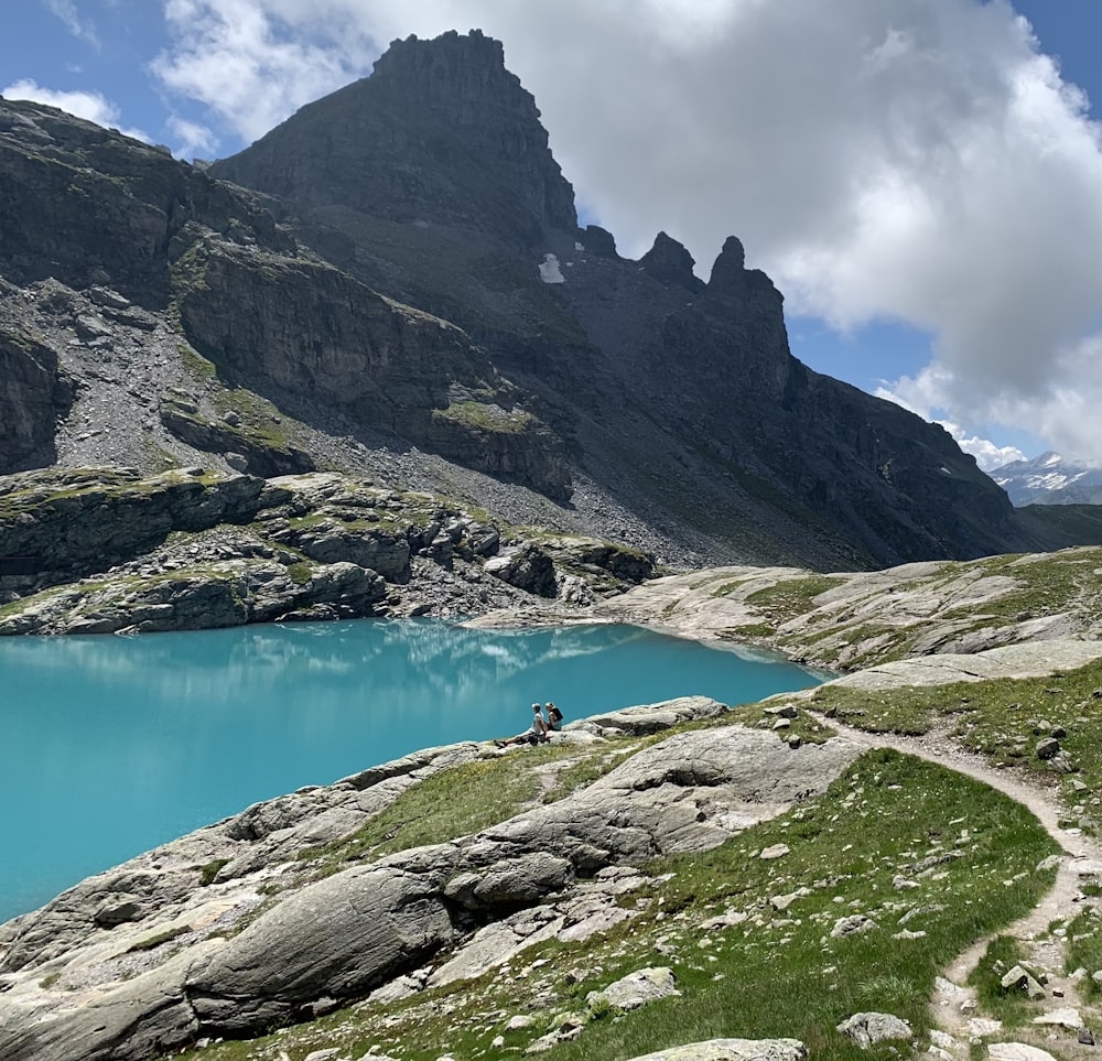 a body of water with a mountain in the background