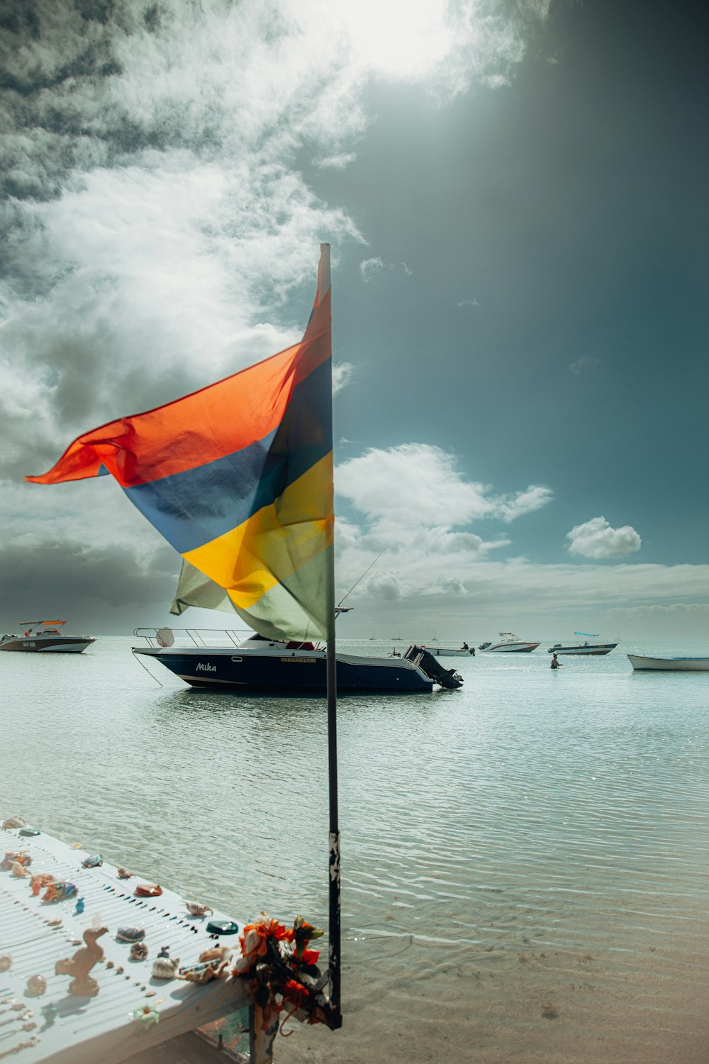 a flag on a pole on a beach