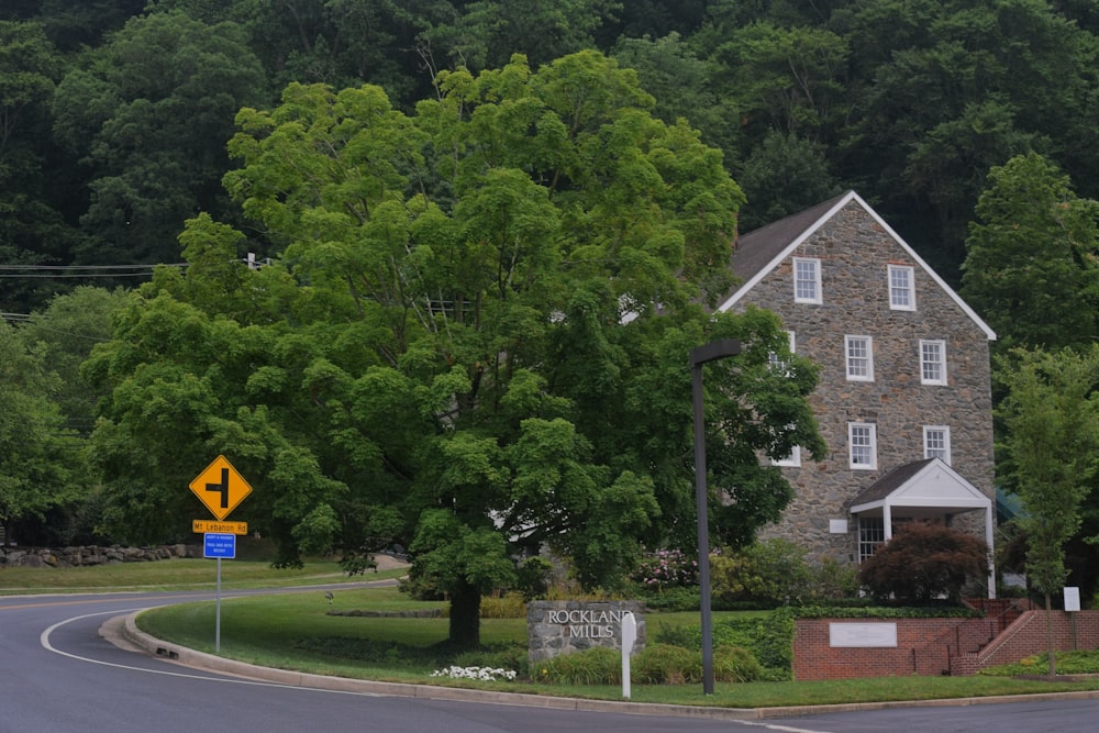 a road with a sign on it and trees in the back