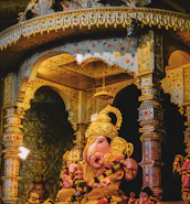 An intricate statue of Lord Shiva bathed in soft golden light inside the temple.