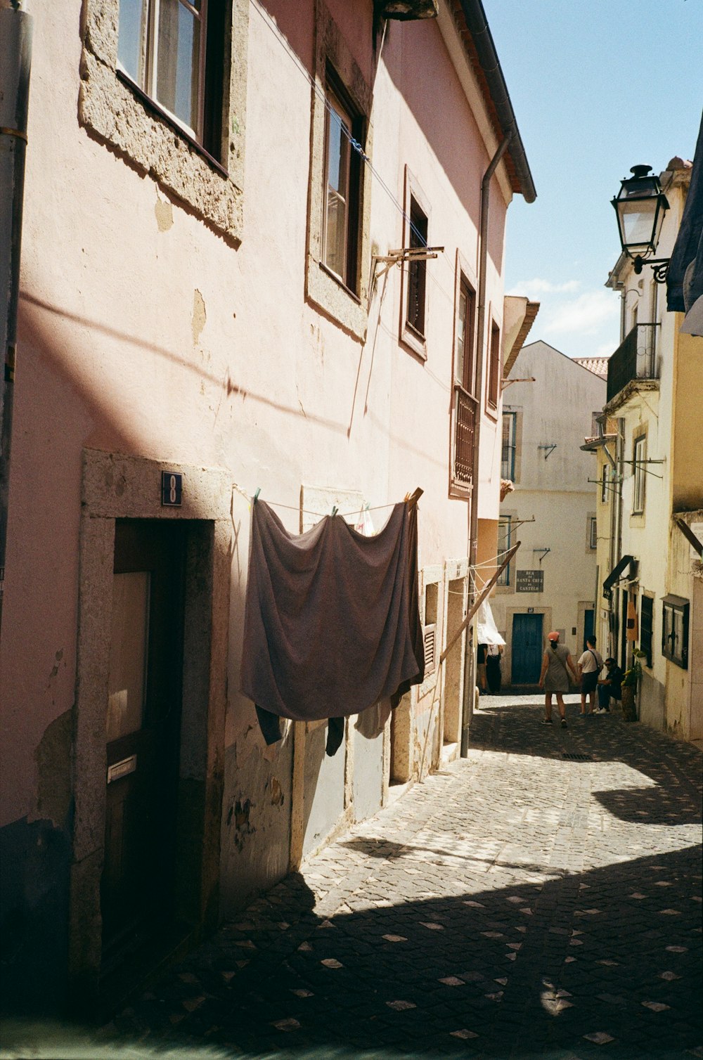 a row of buildings with a red cloth from the roof