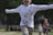 Two kids happily running in Tavtisa clothing in a park.