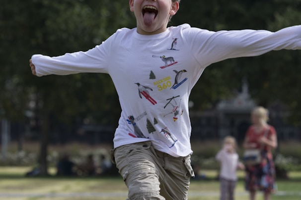 A happy child running outdoors wearing colorful, comfortable metrosfits clothing.