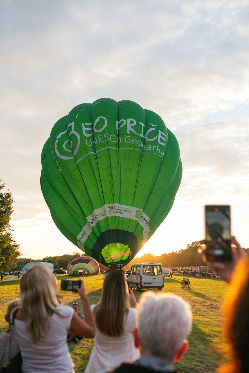 a group of people watching a hot air balloon