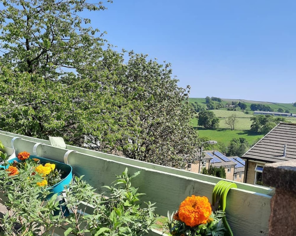 a balcony with a tree and flowers