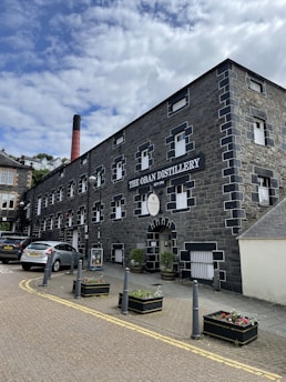 the Oban Distillery with cars in front
