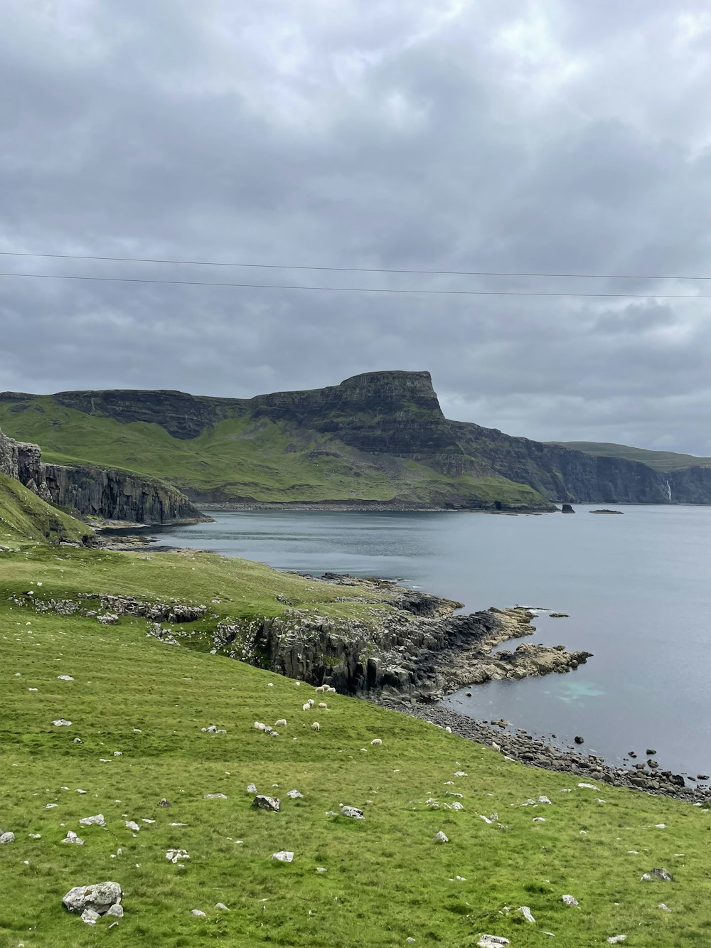 a grassy hill overlooking a body of water