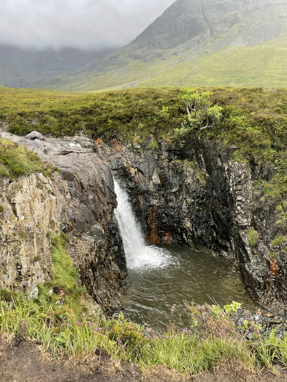 a waterfall in a valley