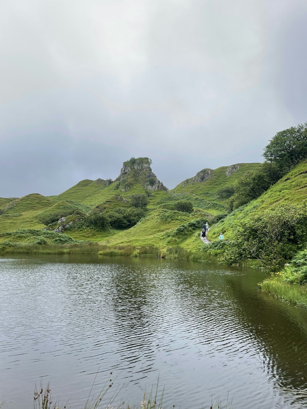 a body of water with hills and trees around it