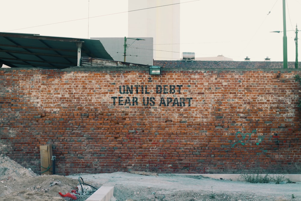 a brick wall with a sign on it