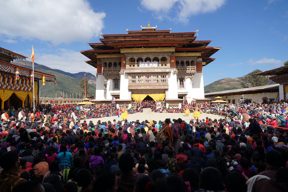 a large crowd of people in front of a building