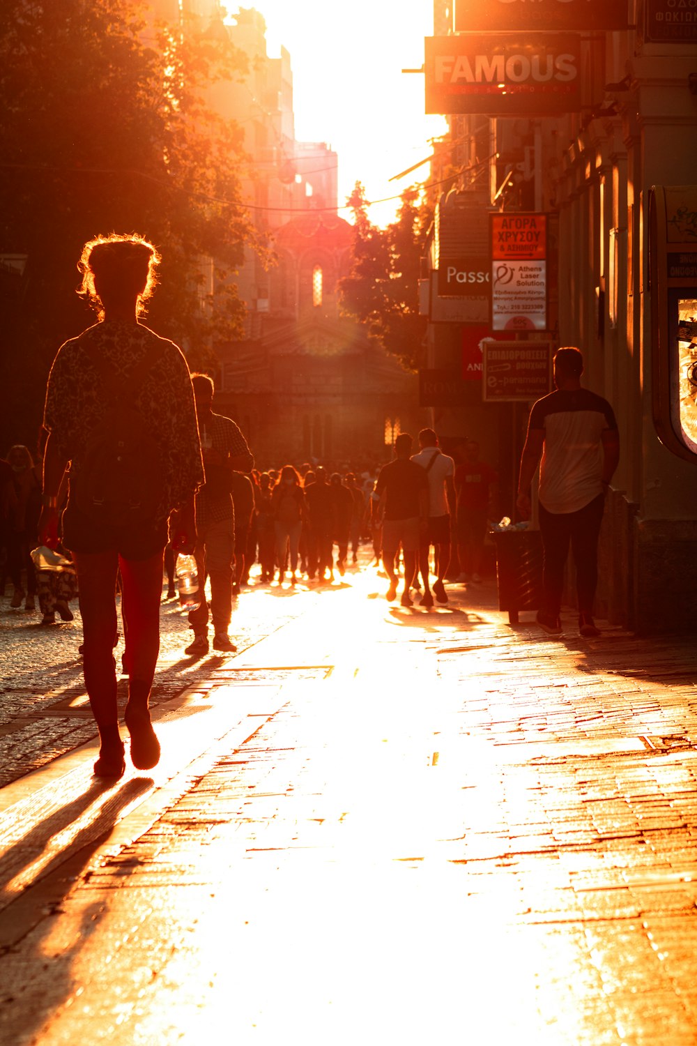 a group of people walking down a street at night