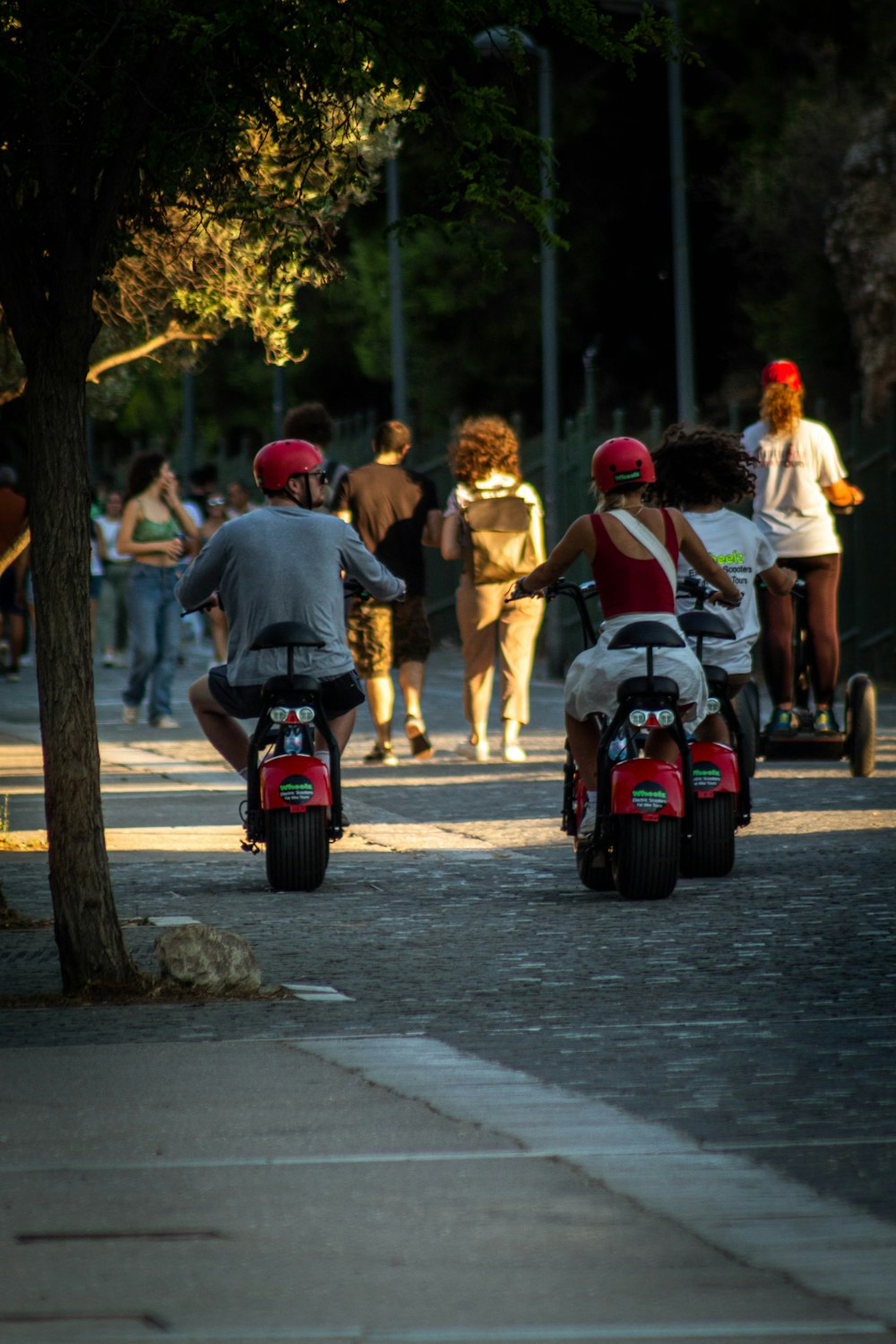 people riding scooters on the street