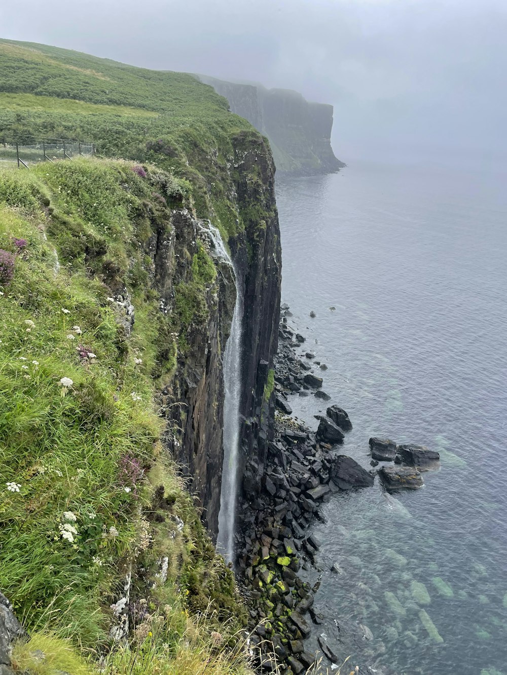 a cliff side with a body of water below